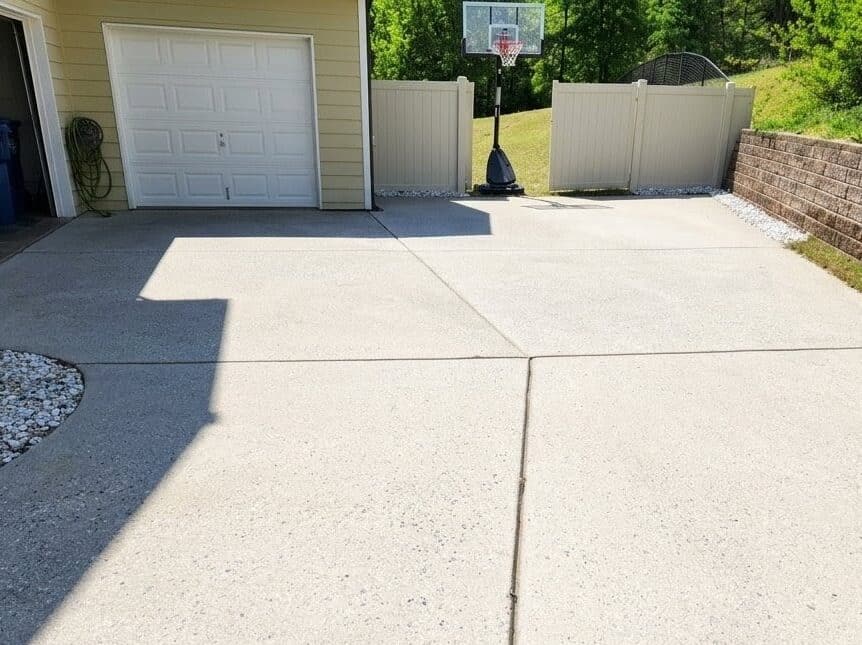 A clean, bright concrete driveway after a professional pressure washing service.